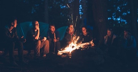 Friends around a bonfire at night